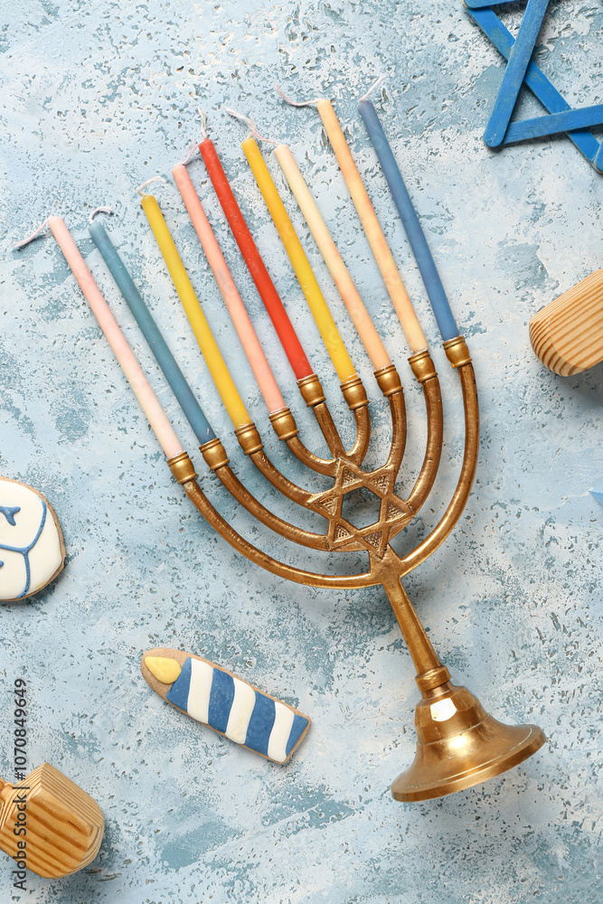 Hannukah composition with menorah and candles on light blue table