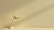 © prime stock - A white desk lamp sits on a light beige table against a matching wall, with soft sunlight casting a shadow.