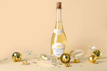 Poster - Bottle of champagne with glasses, Christmas balls and confetti on beige background