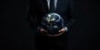 © SKIMP Art - Businessman holding a digital Earth hologram with a global network and connectivity concept on a dark background Generative AI