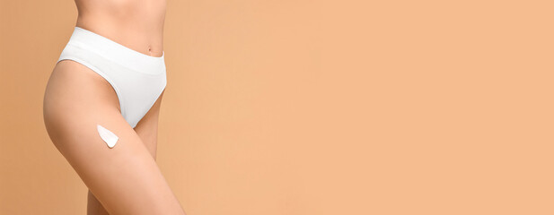 Wall Mural - Woman with cream on skin against dark beige background, closeup. Banner design with space for text. Body care