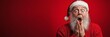 © Katsiaryna - Santa Claus with a surprised expression on his face. Red background, copy space