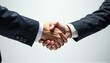 © Kenall - Business professionals engage in a firm handshake during a meeting, symbolizing agreement and collaboration in a corporate setting