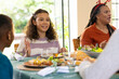 © Wavebreak Media - Multiracial family enjoying festive holiday meal together, at home