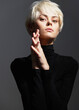 © SHOTPRIME STUDIO - Elegant young woman with short blonde hair posing confidently in a black turtleneck, showcasing modern fashion and a strong, sophisticated attitude.