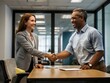 © Rafli - in an office during the day two people are shaking hands after they started working together in business
