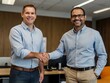 © Rafli - in an office during the day two people are shaking hands after they started working together in business