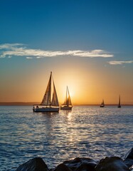 Canvas Print - Sailboats at sunset on the ocean