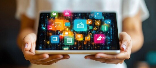 Wall Mural - woman's hands holding a tablet with colorful app icons floating above it.