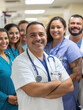 © The Stock Photo Girl - A group of healthcare professionals smiling together in a hospital setting.