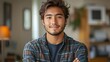 © THE IZEL ART - a young man standing confidently in a casual office, arms crossed, smiling. confident young man in casual office setting
