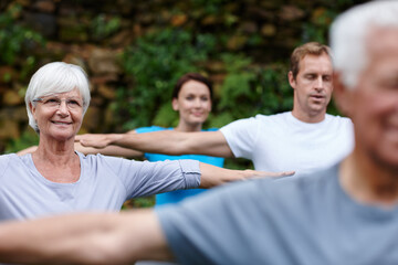 Wall Mural - Stretching, peace and people in nature with yoga class for spiritual retreat, health and zen. Wellness, fitness and connection with group of friends in park for balance, community and pilates