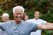© peopleimages.com - Stretching, smile and old man in nature with yoga class for spiritual retreat, peace and zen. Wellness, fitness and connection with group of people in park for balance, community and pilates