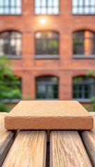 Wall Mural - Wooden tabletop with blurred brick building background.