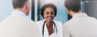 © peopleimages.com - Happy woman, doctor and consulting couple for healthcare, appointment or checkup at hospital. Female person, medical professional or cardiologist with patients on banner for health advice at clinic
