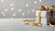 © bahruzrzayev - Close-up of a white gift box with a gold ribbon