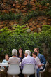 © peopleimages.com - Lunch, bonding and smile with big family in garden for healthy food, nutrition and support. Happiness, eating and celebration with group of people in backyard of home for reunion, care or generations