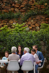 Lunch, bonding and smile with big family in garden for healthy food, nutrition and support. Happiness, eating and celebration with group of people in backyard of home for reunion, care or generations