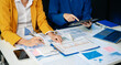 © laddawan - Business documents on office table with smart phone and calculator digital tablet and graph business with social network diagram