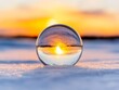 © Albert - A glass ball sitting on top of a snow covered ground