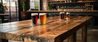 © Ari - Rustic wooden table with craft beers, brewery vibe,