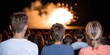 © Kamonwan - Audience watching an explosion performance on stage, captivated by the spectacle.