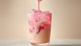 Pouring rose syrup into iced latte.
