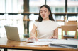© junjira - Asian business woman Give advice to customers via online.