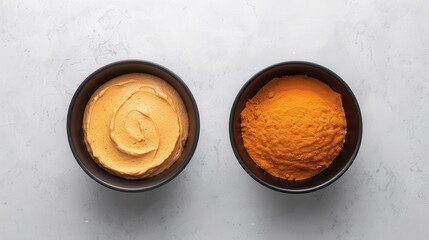 Wall Mural - Brown sugar vegan powder. Two small bowls contain creamy peanut butter and vibrant orange turmeric powder, set against a neutral background.