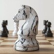 © DZMITRY - Several chess pieces surround a chess knight piece on a board.