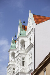 
a white building with red roof tiles on a blue sky background