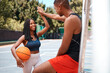 © peopleimages.com - High five, fitness and basketball with black couple on court for sports training, health and teamwork. Workout, personal trainer and exercise with man and woman for wellness, summer and support