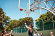 © peopleimages.com - People, playing and air with ball in basketball court for street sports, game or outdoor match. Young community, group or team player with shot for score, point or aim in fun competition or practice
