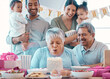 © peopleimages.com - Big family, senior couple and candle blowing with party, cake and love for home birthday celebration. Man, woman and parents with grandchildren, support and event for retirement and holiday bonding