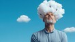 © Anna - A thoughtful man stands outside, gazing upward with a cloud and light bulbs creatively representing his imaginative ideas against a bright blue sky
