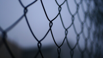 Chain-link mesh close-up, metal fencing, fog, pattern