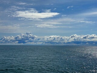 Wall Mural - blue sea sparkling water and beautiful sky clouds