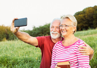 Wall Mural - woman man outdoor senior couple happy lifestyle retirement together smiling love selfie camera matur