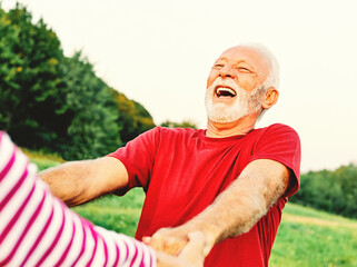 Wall Mural - woman man outdoor senior couple happy lifestyle retirement together smiling love dancing fun playing