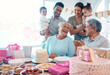 © peopleimages.com - Big family, senior couple and laughing with birthday celebration, cake and love for home party. Mature man, woman and grandparents with children, support and event for retirement and holiday bonding