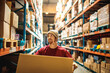 © Davor - Warehouse worker carrying box