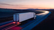 © Concept Photo Studio - Camion roulant sur une route de campagne le soir
