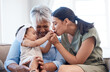 © peopleimages.com - Love, relax and baby with mother and grandma in living room for playing and bonding together. Fun, kiss and infant child with mom and senior woman for generational family time on sofa in home.