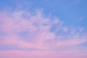 Wall Mural - A beautiful sky tinted by the sun leaving vibrant shades of gold, pink, blue and multicolored. Clouds in the twilight evening and morning sky. Cloudy sky background in the evening, and during the day.