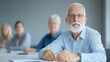 © Riko - Portrait of elderly man with white beard and glasses, sitting in a meeting with blurred group members in the background