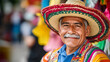 © Jhati - A smiling Mexican man in a colorful sombrero celebrates Mexican Independence Day in the plaza
