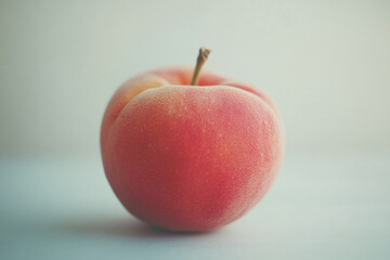 Wall Mural - A whole fuzzy peach, against a white background.