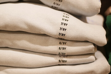 Stack of Beige Textile Fabrics with Size Markings