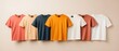 © javu - Colorful assortment of plain t-shirts arranged neatly, showcasing various hues.