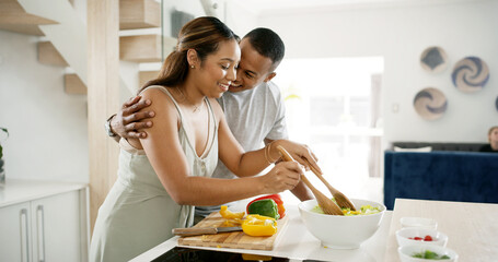 Couple, kitchen and hug with vegetable for salad at home for meal prep, lunch and nutrition. Apartment, people and happy or smile in relationship with food on bowl for support, love and bonding